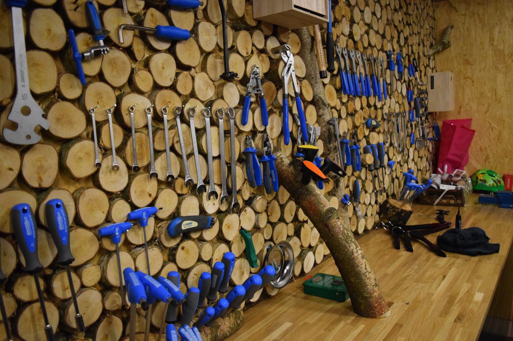 Many tools hanging on a wall